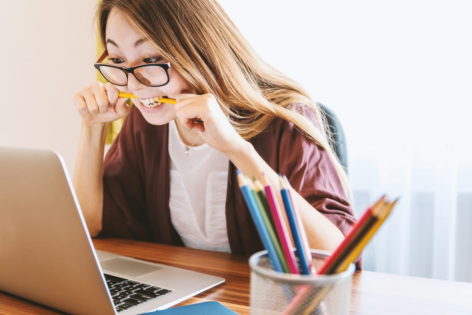 A student thinking through a question at a laptop